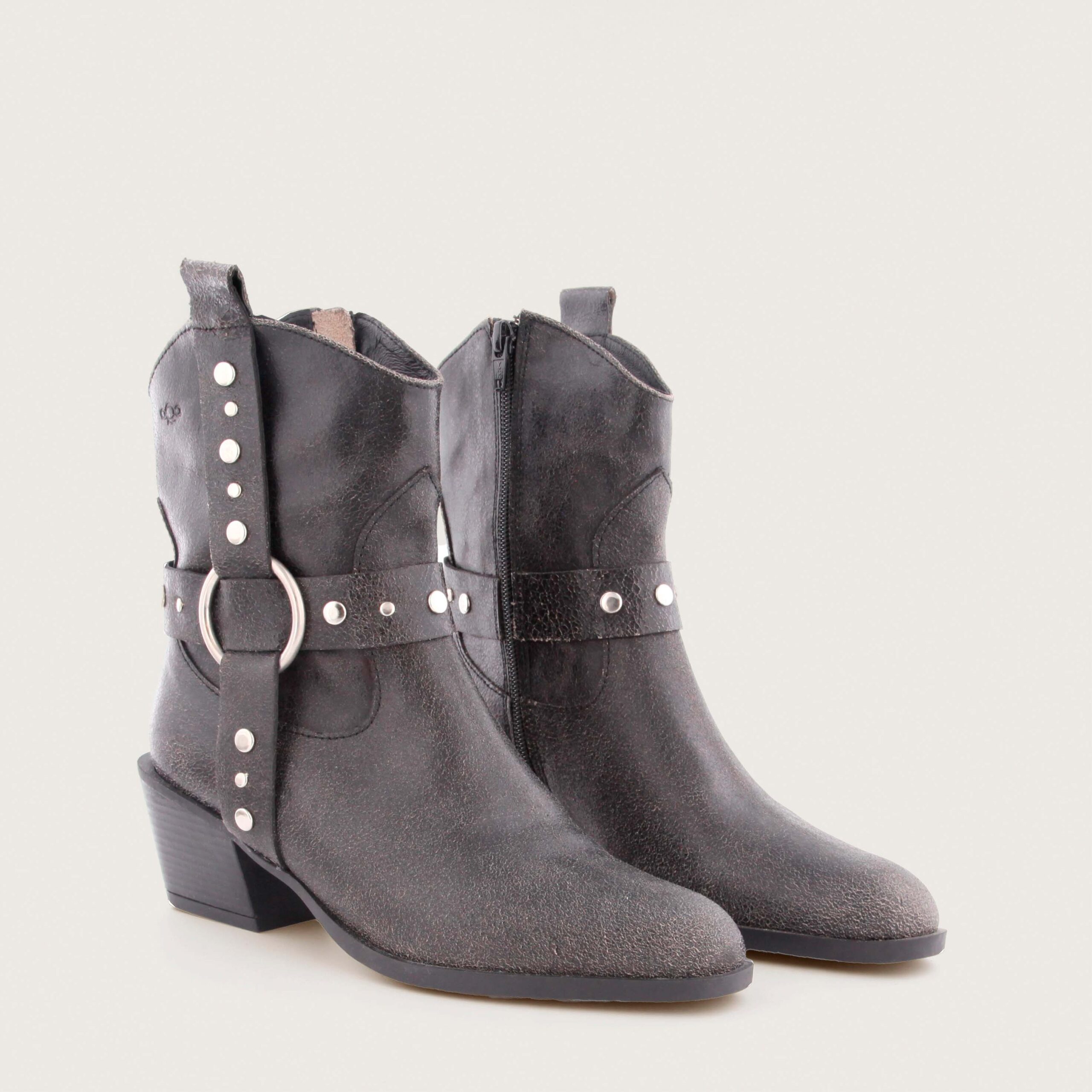 Black textured leather western-style ankle boot with metal ring and studded strap by AQA, model Sofia.