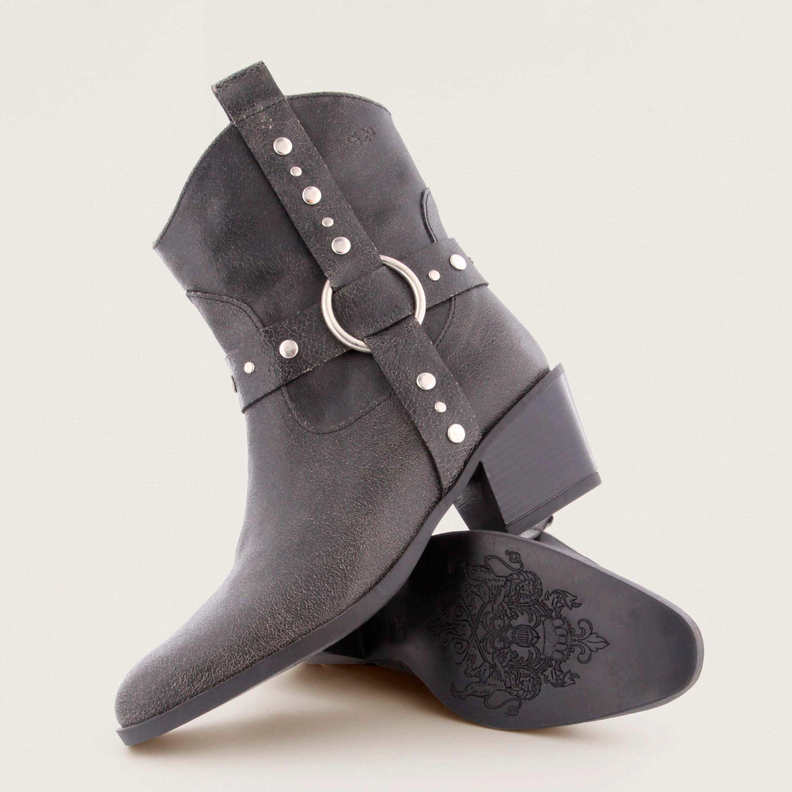 Black textured leather western-style ankle boot with metal ring and studded strap by AQA, model Sofia.